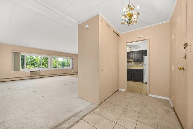 an empty room with windows and entrance