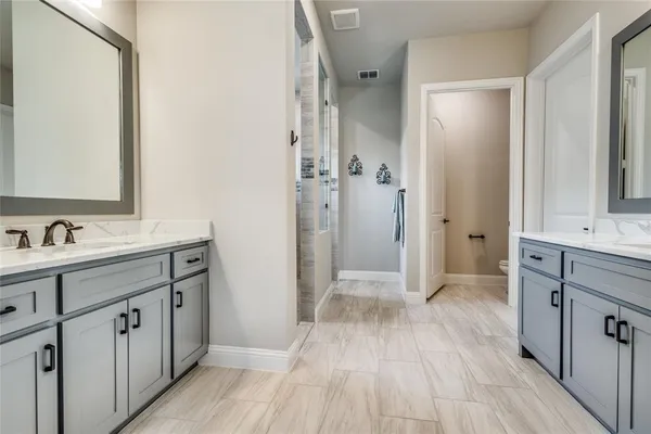 a bathroom with a sink mirror and a shower