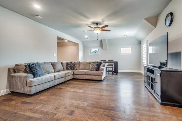 a living room with furniture and a ceiling fan