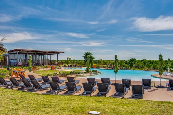 a view of a swimming pool with a garden and outdoor seating