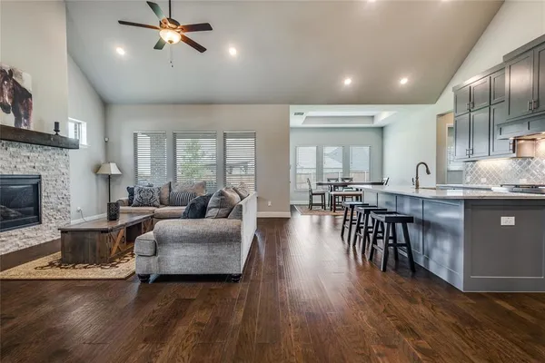 a living room with furniture and a wooden floor
