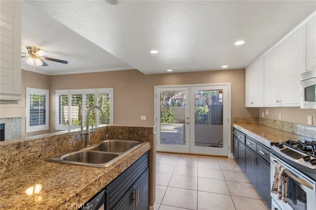 a kitchen with a sink stove top oven and cabinets