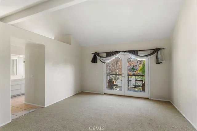 an empty room with windows and entrance