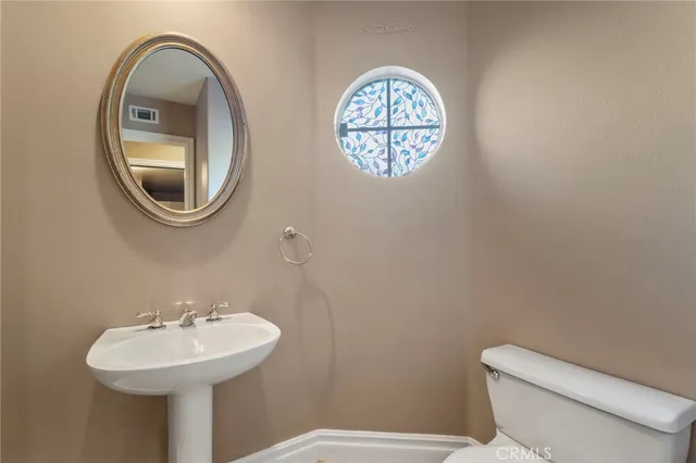 a bathroom with a toilet and a sink
