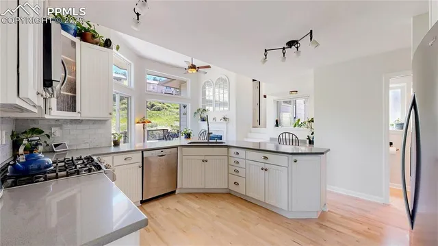 a kitchen with stainless steel appliances granite countertop a sink and cabinets