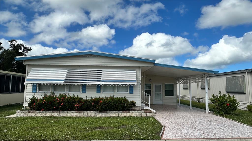 5619 Bayshore Road, Unit 163 Palmetto, FL 34221 - Photo 1 of 44 a front view of a house with a yard and garage