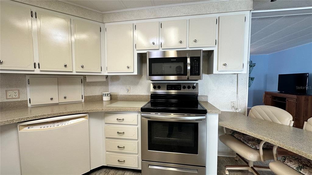 5619 Bayshore Road, Unit 163 Palmetto, FL 34221 - Photo 16 of 44 a kitchen with stainless steel appliances white cabinets and stove