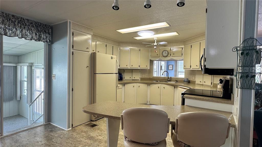 5619 Bayshore Road, Unit 163 Palmetto, FL 34221 - Photo 17 of 44 a kitchen with stainless steel appliances granite countertop a sink refrigerator and cabinets
