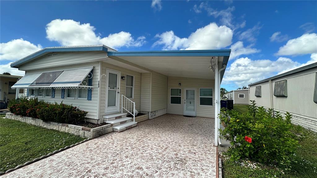 5619 Bayshore Road, Unit 163 Palmetto, FL 34221 - Photo 2 of 44 a front view of a house with garden