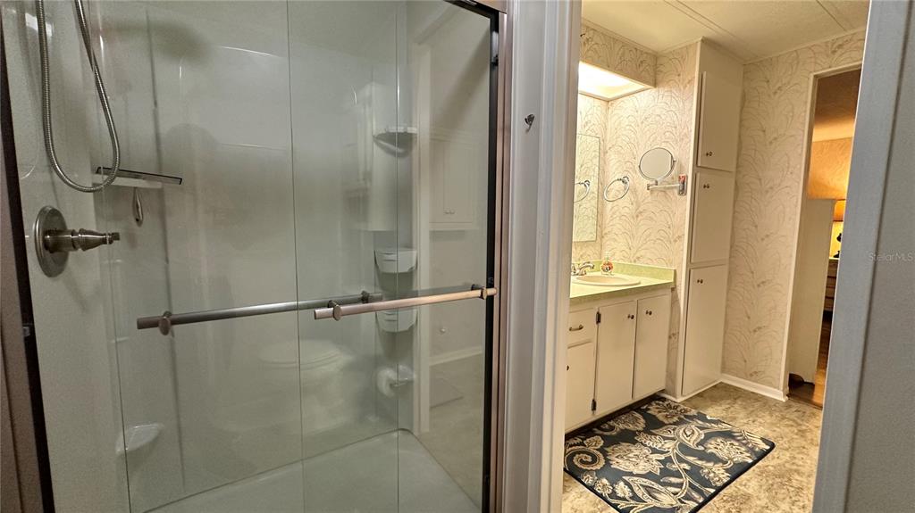 5619 Bayshore Road, Unit 163 Palmetto, FL 34221 - Photo 23 of 44 a bathroom with a glass shower door