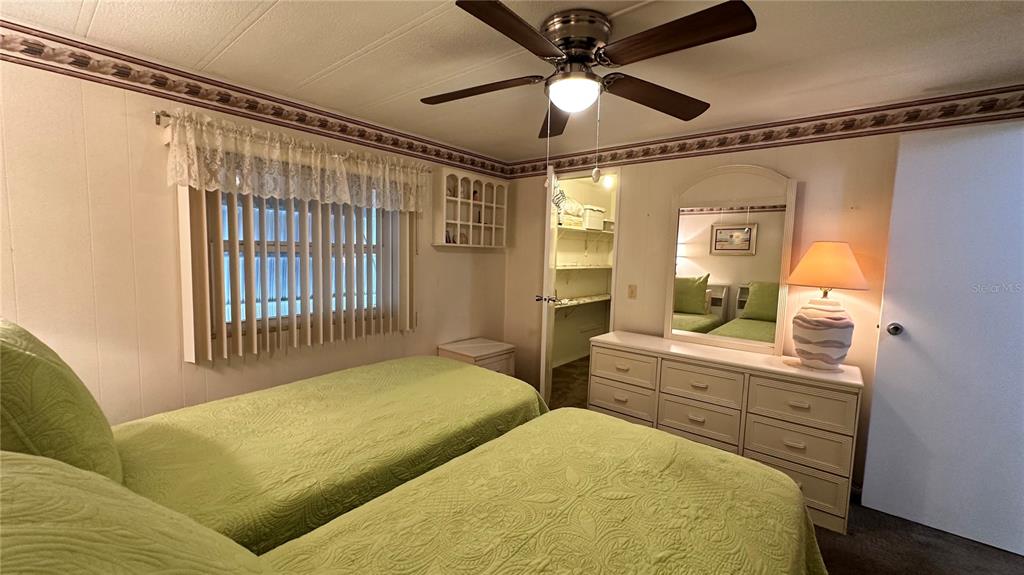 5619 Bayshore Road, Unit 163 Palmetto, FL 34221 - Photo 25 of 44 a bedroom with a bed and a chandelier