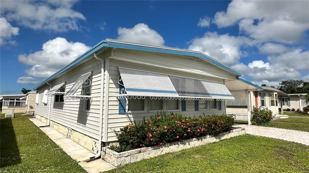 5619 Bayshore Road, Unit 163 Palmetto, FL 34221 - Photo 3 of 44 a front view of house along with deck and outdoor seating