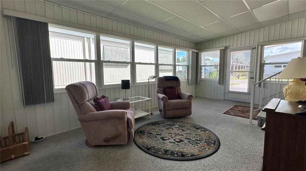 5619 Bayshore Road, Unit 163 Palmetto, FL 34221 - Photo 32 of 44 a living room with furniture a large window and a table