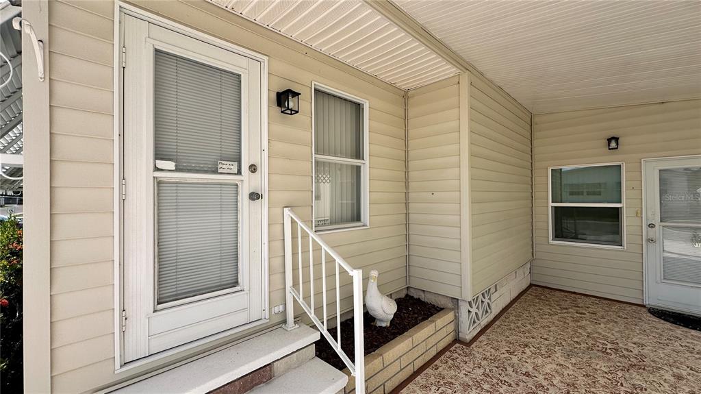 5619 Bayshore Road, Unit 163 Palmetto, FL 34221 - Photo 34 of 44 a view of a porch with a door and wooden floor