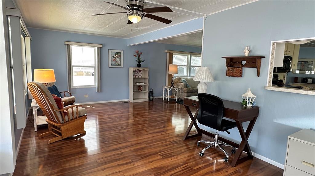 5619 Bayshore Road, Unit 163 Palmetto, FL 34221 - Photo 4 of 44 a living room with furniture and a wooden floor