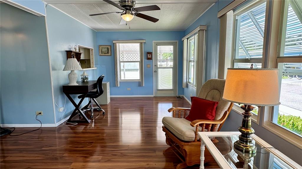 5619 Bayshore Road, Unit 163 Palmetto, FL 34221 - Photo 5 of 44 a living room with furniture and a wooden floor