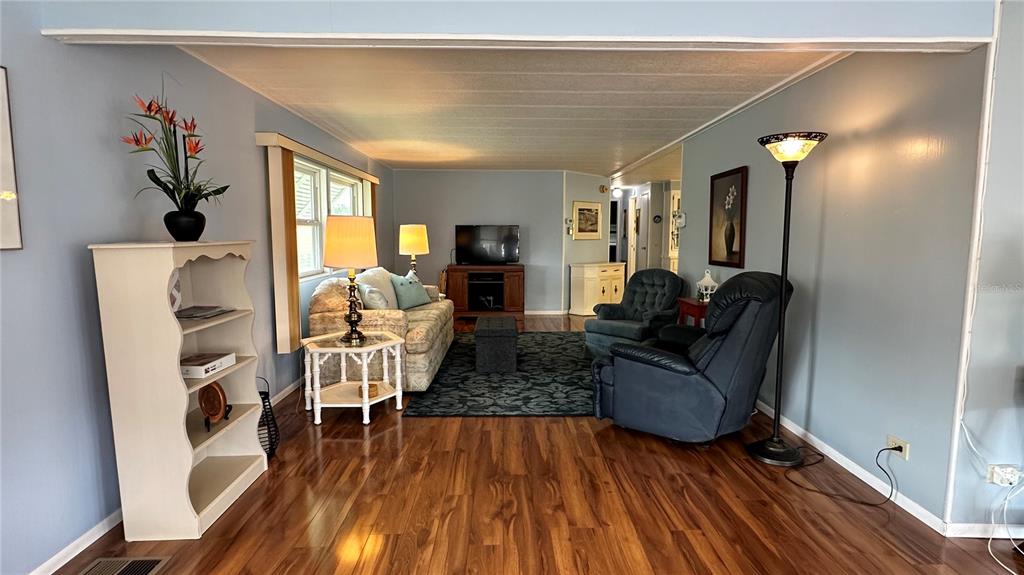 5619 Bayshore Road, Unit 163 Palmetto, FL 34221 - Photo 6 of 44 a living room with furniture and a wooden floor
