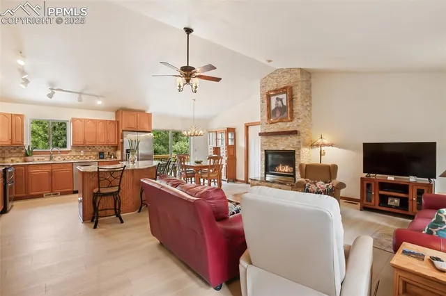 a living room with furniture a fireplace and a flat screen tv