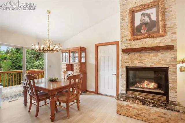 a dining room with furniture a fireplace and chandelier