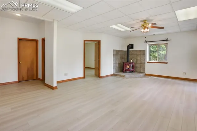 a view of a livingroom with a chandelier furniture and a window