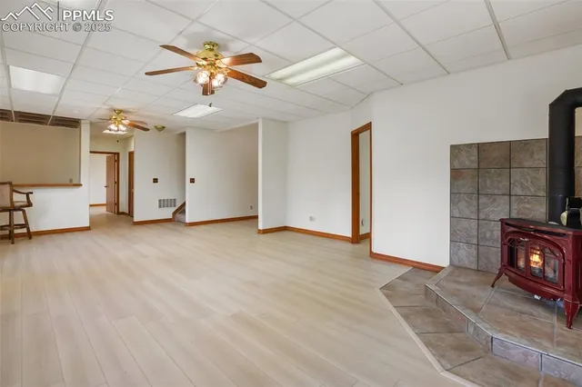 a view of an empty room with a fireplace