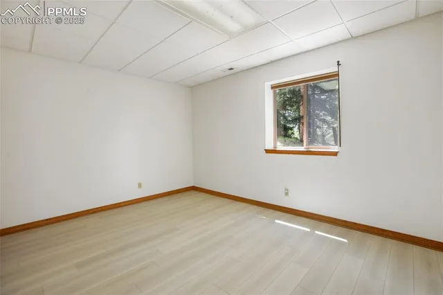 a view of a room with a wooden floor and a window