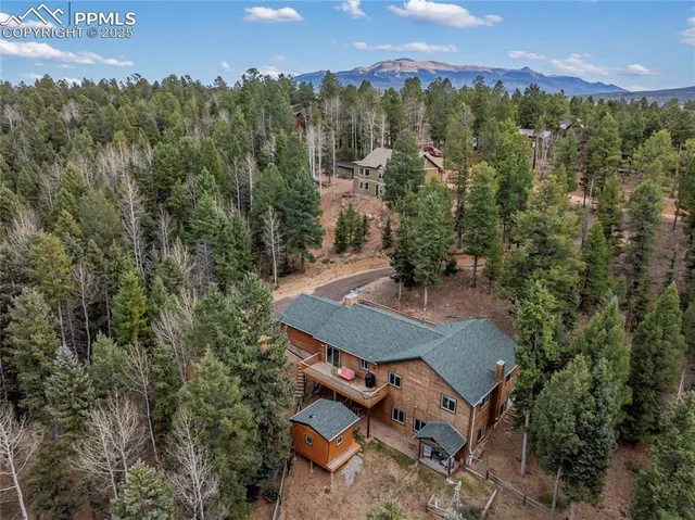 an aerial view of a house with mountain view
