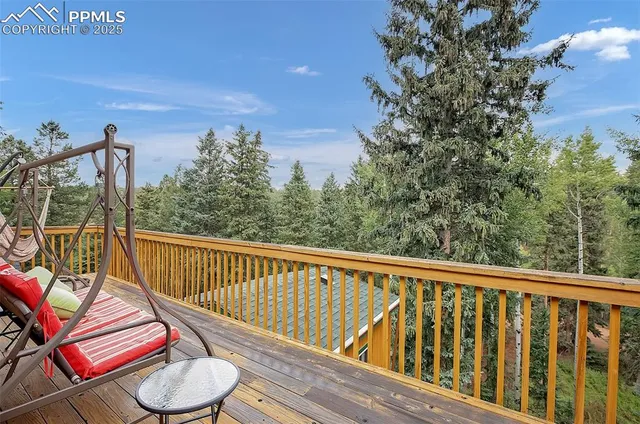 a view of a balcony with chair and wooden floor