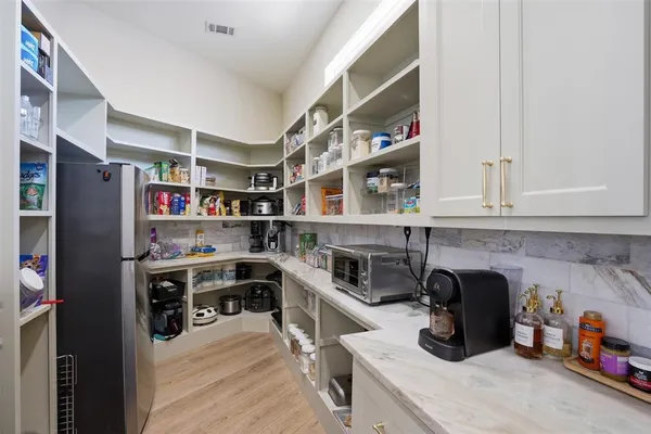 a kitchen with stainless steel appliances granite countertop a refrigerator and a stove