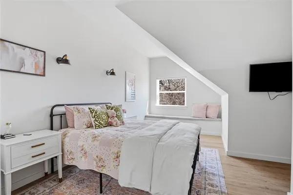 a bedroom with a large bed and a flat screen tv