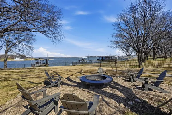 a view of a lake with two chairs
