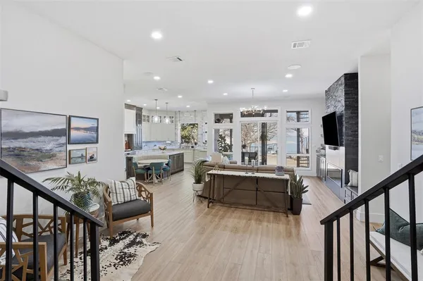a living room with furniture flat screen tv and couches