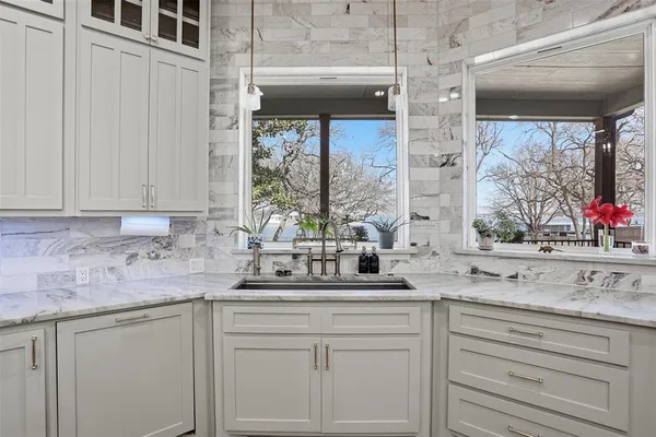 a kitchen with stainless steel appliances white cabinets and a granite counter tops