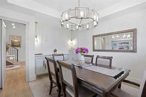 a view of a dining room with furniture and chandelier