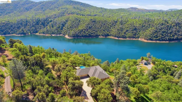 an aerial view of a houses with a lake view