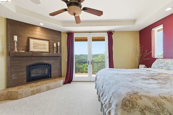 a bedroom with furniture and a fireplace
