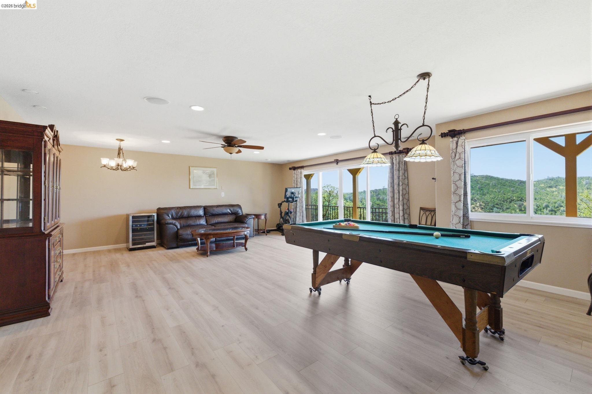 12808 Mammoth Mine Road Jamestown, CA 95327 - Photo 28 of 60 Recreation room featuring billiards table, a ceiling fan, light wood-style floors, wine cooler, and hanging lights