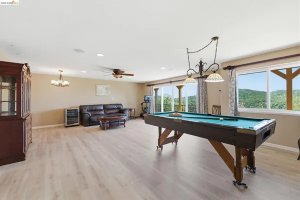 a room with pool table and windows
