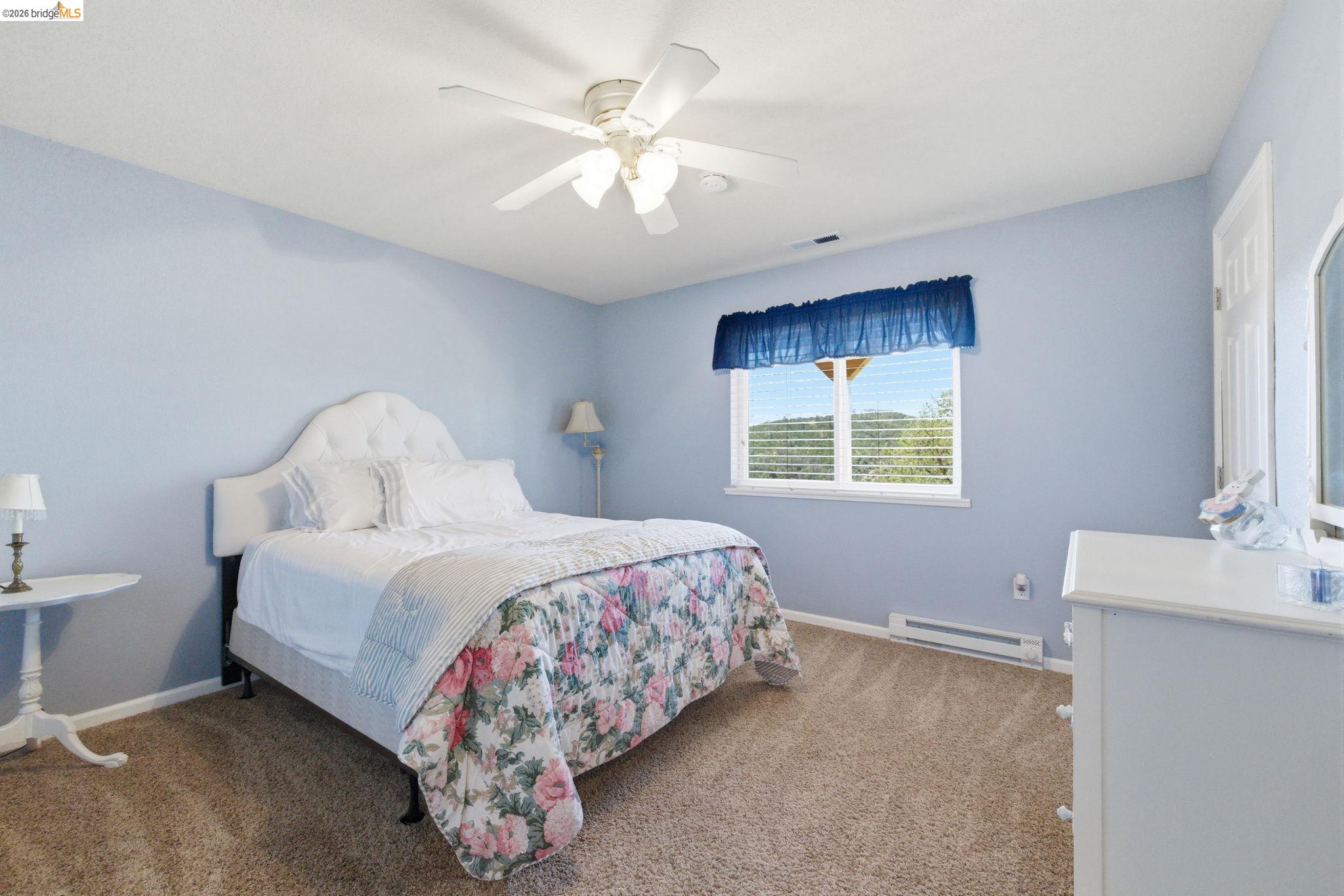 12808 Mammoth Mine Road Jamestown, CA 95327 - Photo 31 of 60 Bedroom with a baseboard heating unit, a ceiling fan, and light colored carpet