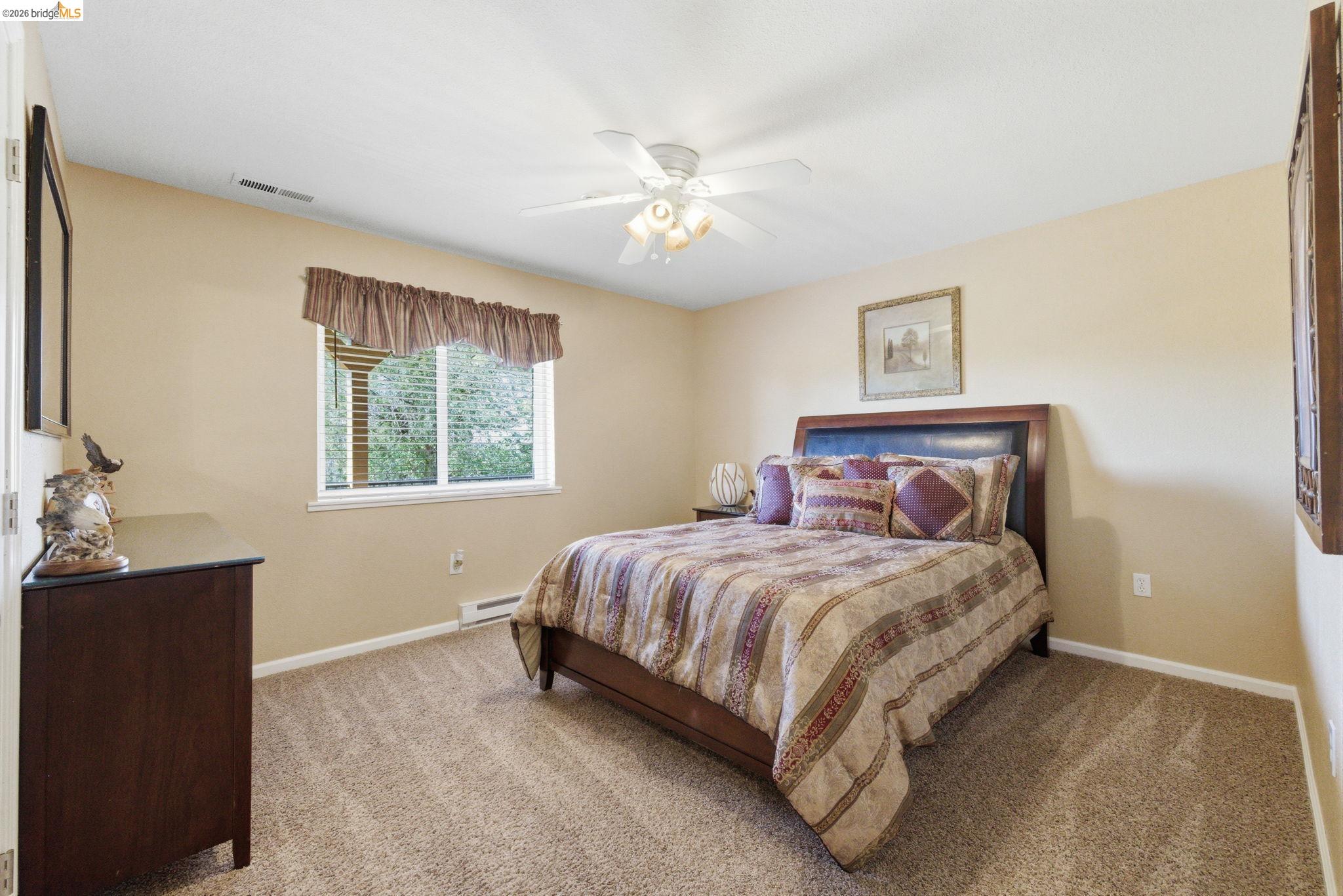 12808 Mammoth Mine Road Jamestown, CA 95327 - Photo 33 of 60 Bedroom featuring light carpet, ceiling fan, and a baseboard radiator