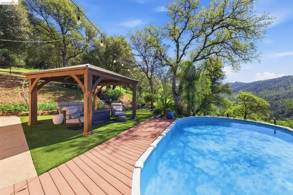a patio with water view fountain with outdoor seating