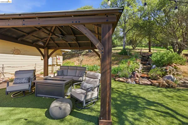 a backyard of a house with a yard and outdoor seating
