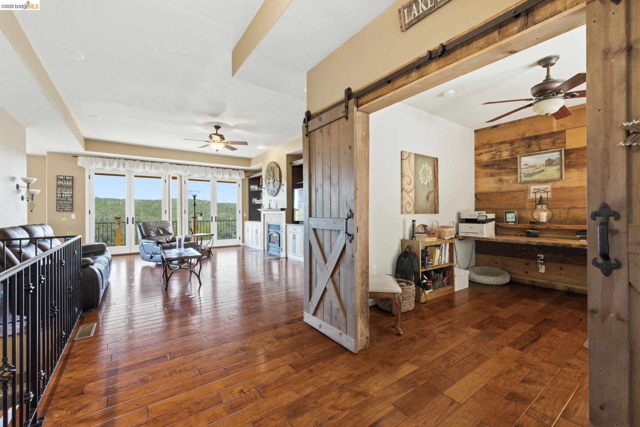 12808 Mammoth Mine Road Jamestown, CA 95327 - Photo 7 of 60 Corridor with a barn door, dark wood-style flooring, and wood walls