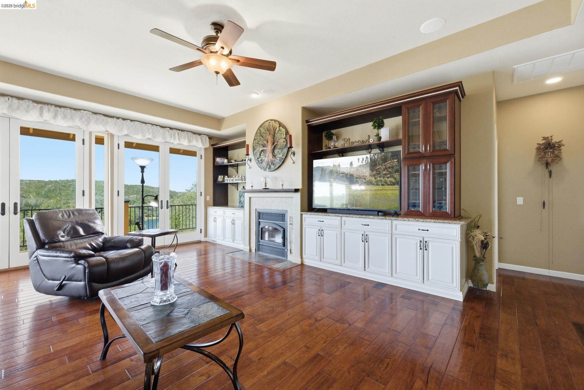 12808 Mammoth Mine Road Jamestown, CA 95327 - Photo 9 of 60 Living room featuring a ceiling fan, dark wood-type flooring, and built in features