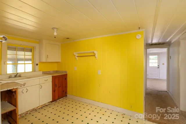 a bathroom with a sink mirror and a shower
