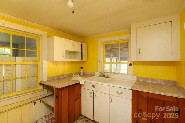 a kitchen with a sink stove and cabinets