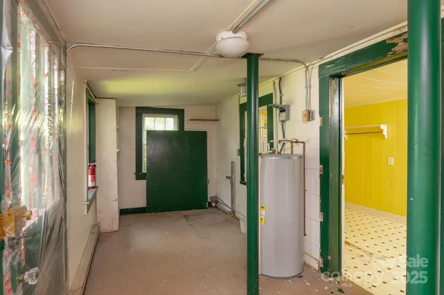 a view of a hallway with wooden floor and a living room