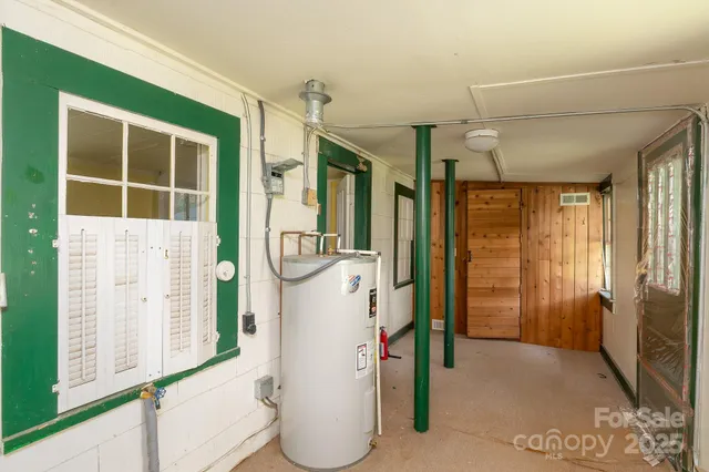 a view of wooden house with a small yard and wooden fence
