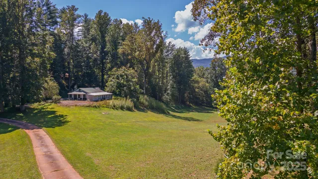 a view of a yard with a swimming pool and outdoor space