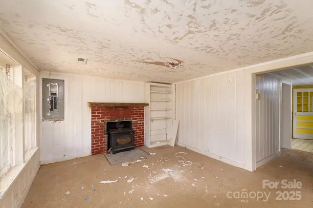 a view of a livingroom with an empty space and fire place